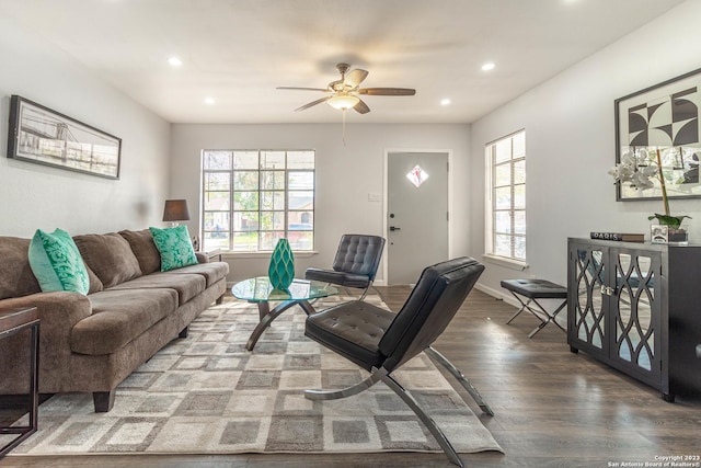 living room featuring hardwood / wood-style floors and ceiling fan