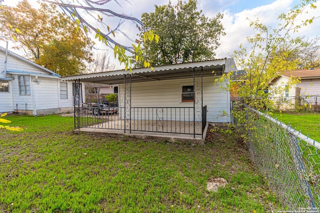 back of property featuring a lawn