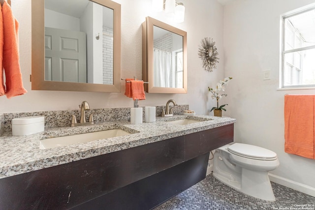 bathroom with vanity, toilet, and tile patterned floors