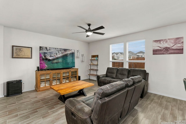 living room featuring light hardwood / wood-style flooring and ceiling fan