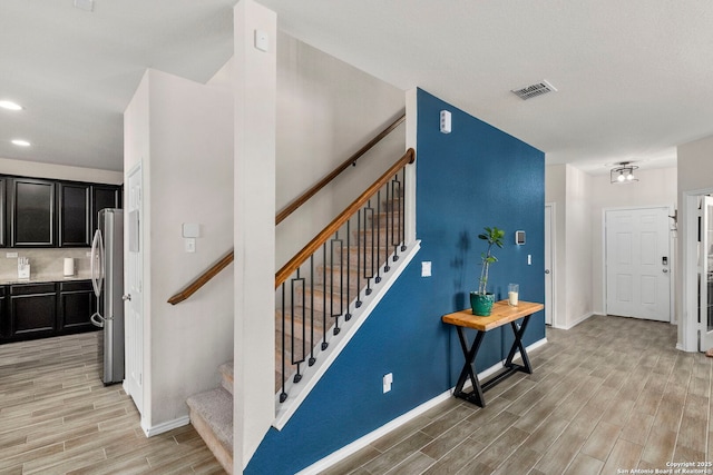 stairs with hardwood / wood-style floors