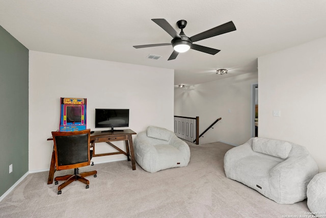 office featuring ceiling fan and light carpet