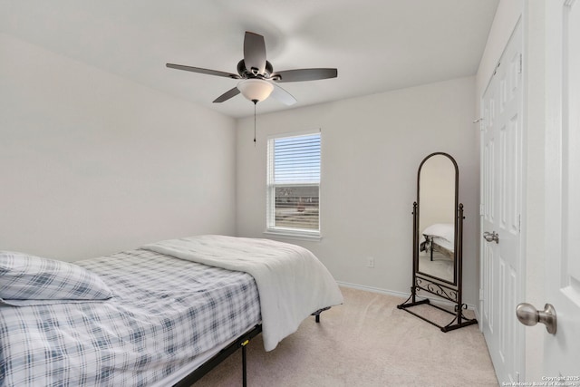 carpeted bedroom featuring a closet and ceiling fan