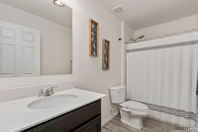 bathroom with vanity, toilet, and a shower with shower curtain