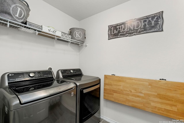 clothes washing area featuring washer and clothes dryer