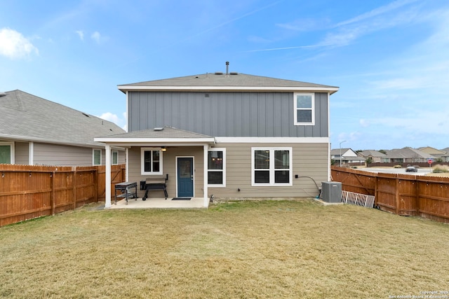 rear view of house featuring a lawn, a patio, and cooling unit