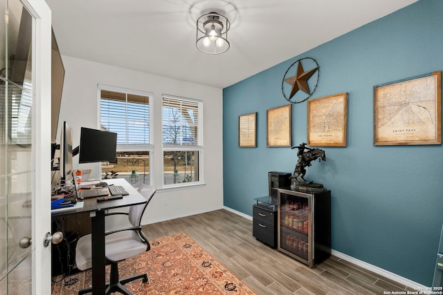 home office with light hardwood / wood-style floors