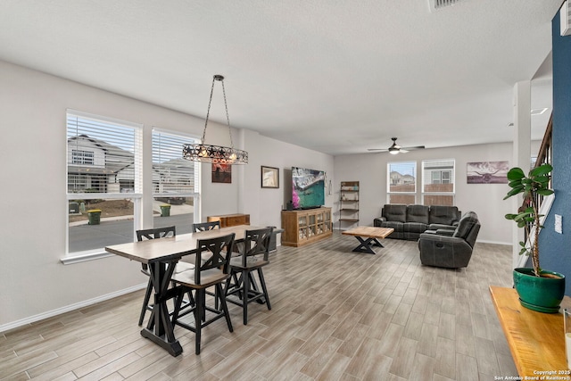 dining room featuring light hardwood / wood-style floors, ceiling fan, and plenty of natural light