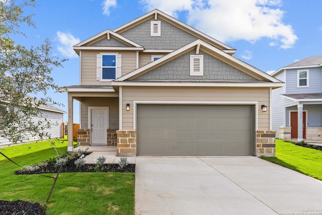 craftsman house featuring a front yard and a garage