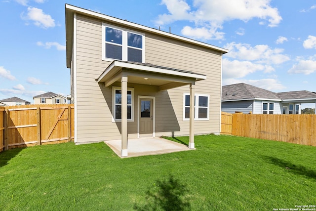 back of property featuring a yard and a patio