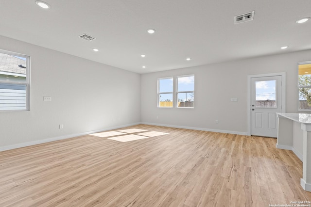 unfurnished living room featuring light wood-type flooring