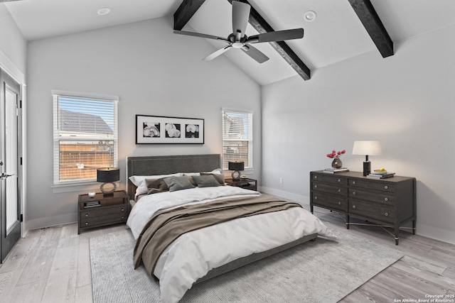 bedroom with ceiling fan, beam ceiling, and multiple windows