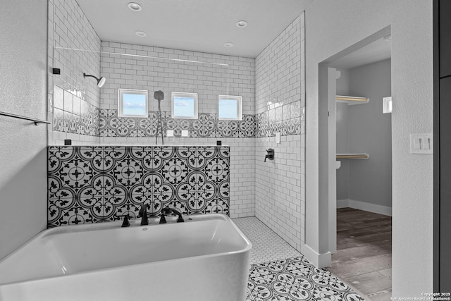 bathroom featuring tile patterned floors and plus walk in shower