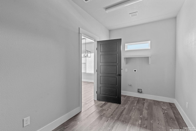 unfurnished room with dark hardwood / wood-style flooring and a healthy amount of sunlight