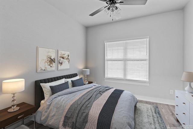 bedroom with ceiling fan and light hardwood / wood-style floors