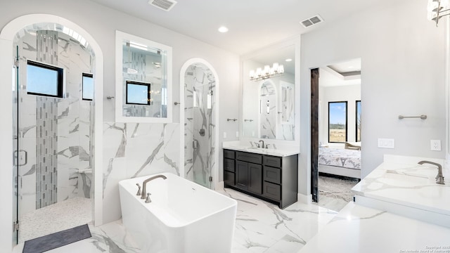 bathroom with vanity and shower with separate bathtub