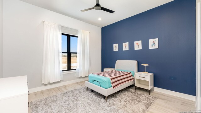 bedroom featuring wood-type flooring and ceiling fan