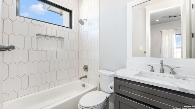 full bathroom featuring vanity, toilet, and tiled shower / bath