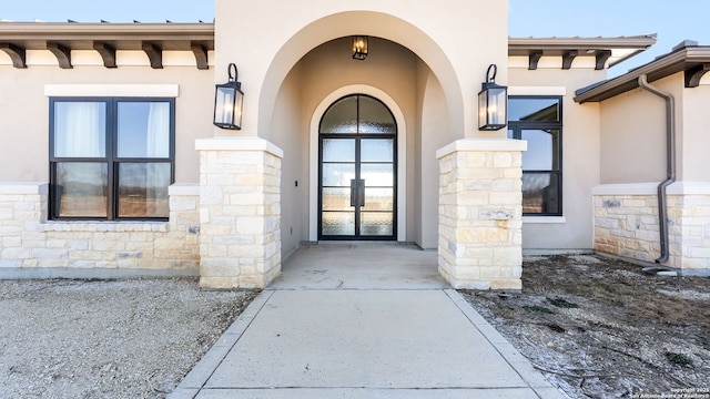 view of exterior entry featuring french doors