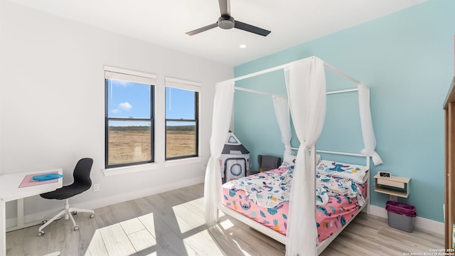 bedroom featuring ceiling fan and light hardwood / wood-style flooring