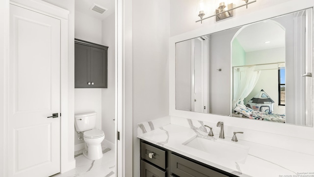 bathroom with vanity and toilet