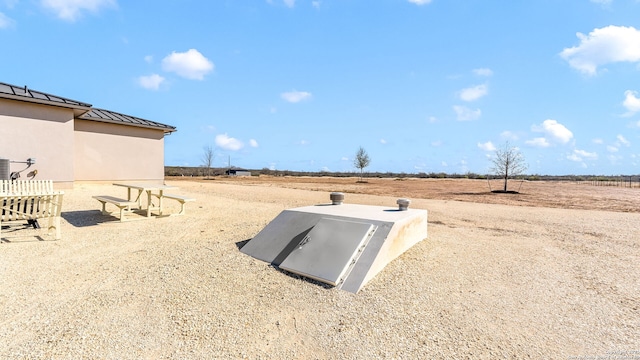 view of storm shelter featuring a rural view