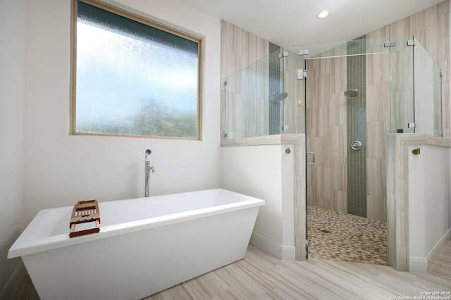 bathroom with shower with separate bathtub