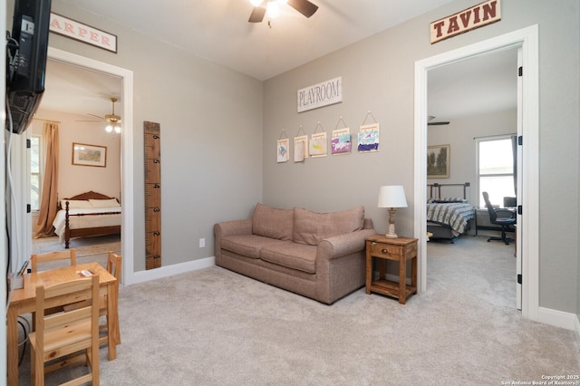 carpeted living room featuring ceiling fan