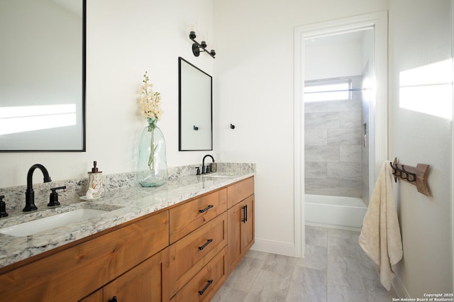 bathroom featuring vanity and tiled shower / bath