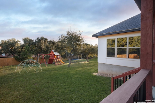 view of yard featuring a playground and a trampoline