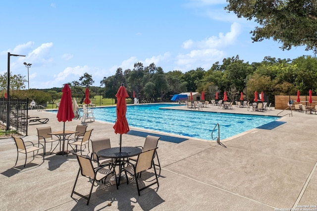 view of swimming pool with a patio