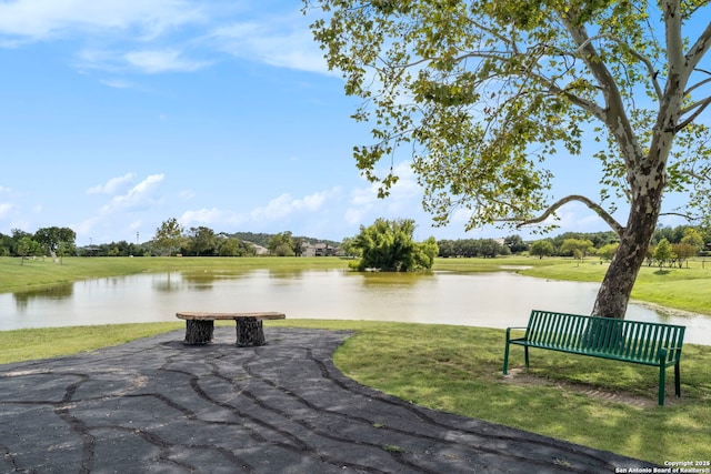 surrounding community featuring a water view and a yard