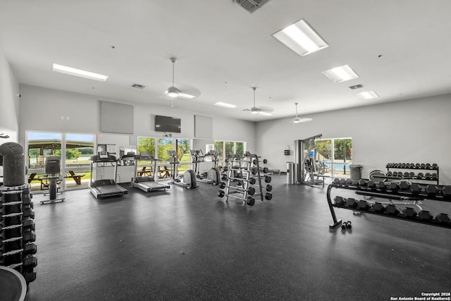 workout area featuring a towering ceiling