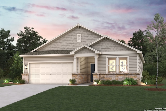 craftsman house featuring a garage and a yard