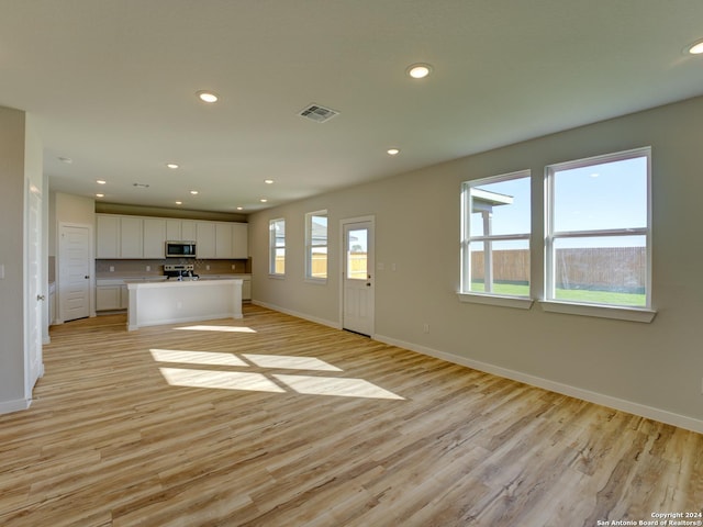 unfurnished living room with light hardwood / wood-style flooring