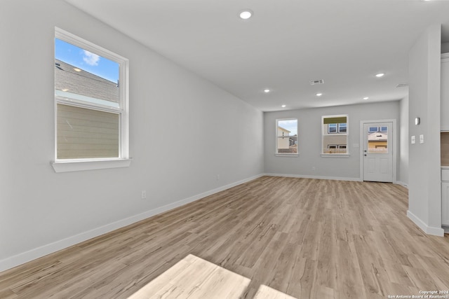 interior space with plenty of natural light and light hardwood / wood-style floors