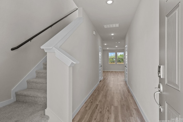 hallway with light hardwood / wood-style flooring