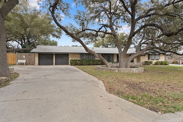 ranch-style home with a garage and a front yard