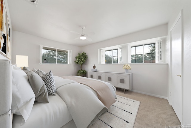 bedroom with light colored carpet and ceiling fan