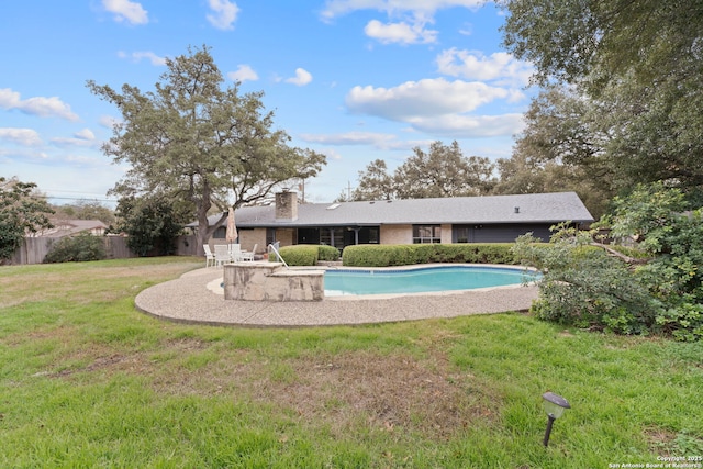 view of pool with a patio area and a yard