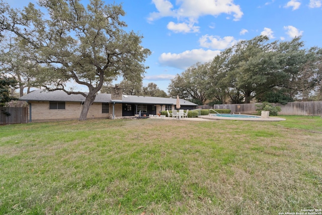 view of yard with a fenced in pool and a patio