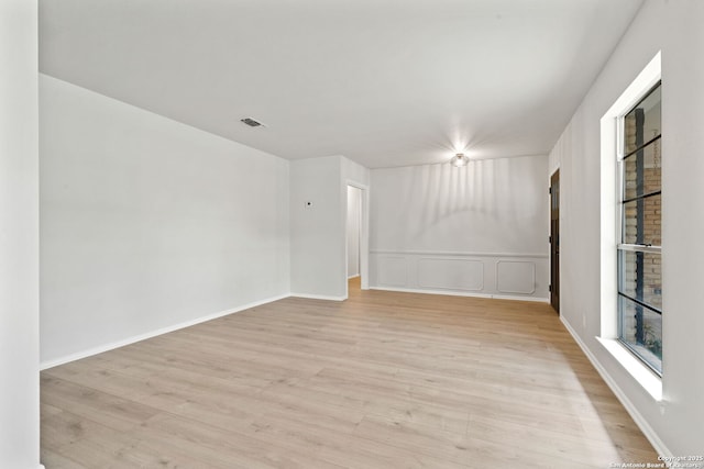 empty room with light hardwood / wood-style flooring