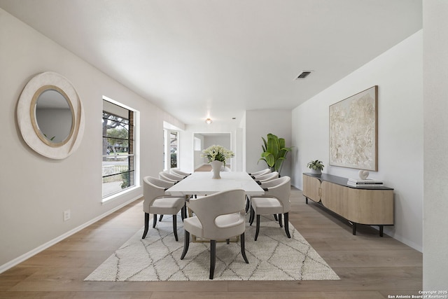 dining area with light hardwood / wood-style floors