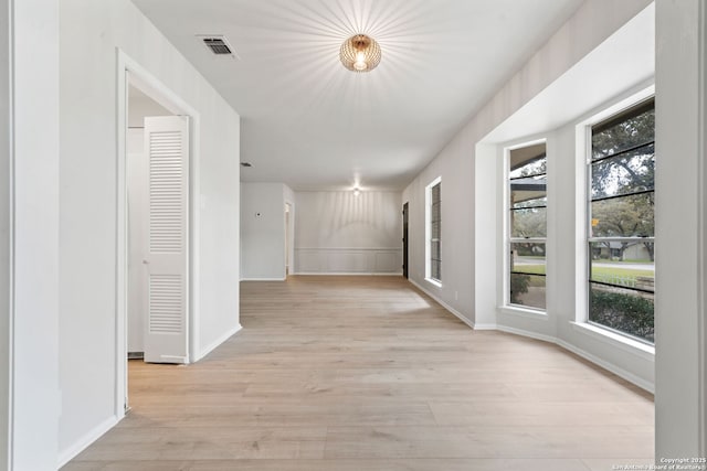 corridor with light hardwood / wood-style flooring