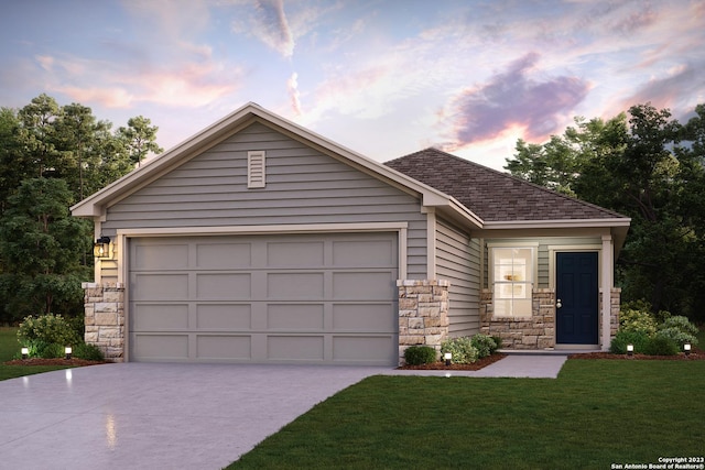 view of front of home featuring a garage and a yard