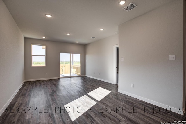 empty room featuring dark hardwood / wood-style flooring