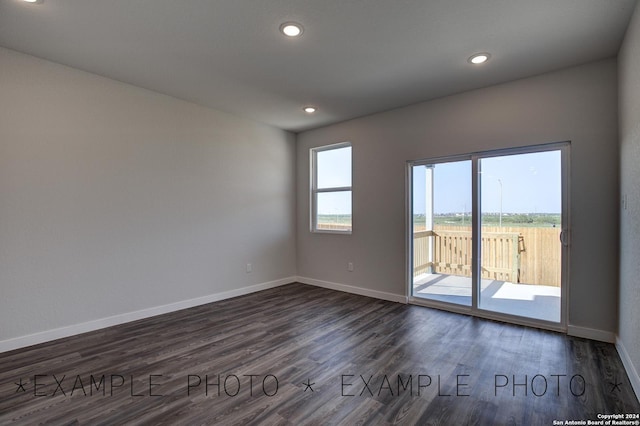 spare room with dark hardwood / wood-style flooring