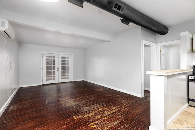 unfurnished living room featuring light hardwood / wood-style floors, a wall mounted AC, beamed ceiling, and french doors