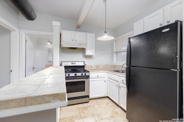 kitchen with white cabinets, hanging light fixtures, black fridge, and stainless steel range with gas cooktop