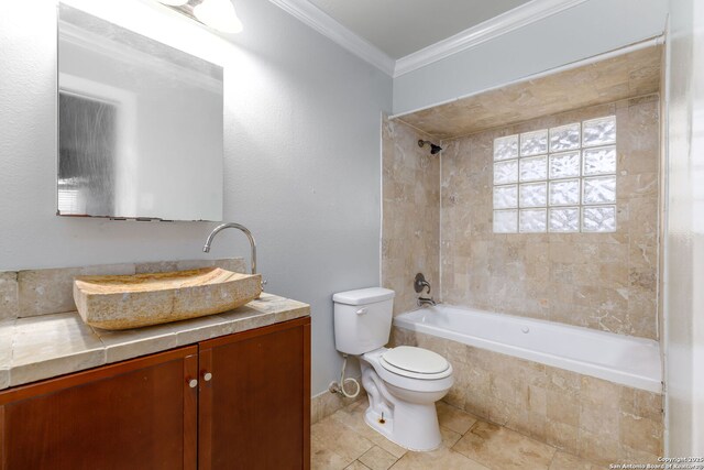 full bathroom featuring toilet, vanity, ornamental molding, and tiled shower / bath